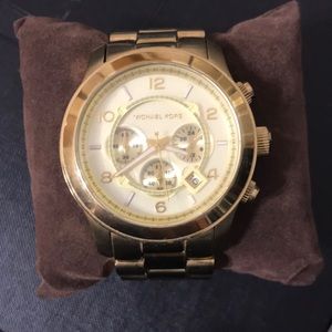 Authentic Michael Kors large faced gold watch.